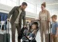 Family using a compact travel stroller at the airport during a family trip