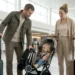 Family using a compact travel stroller at the airport during a family trip
