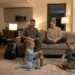 Family relaxing inside a cozy Airbnb apartment during vacation